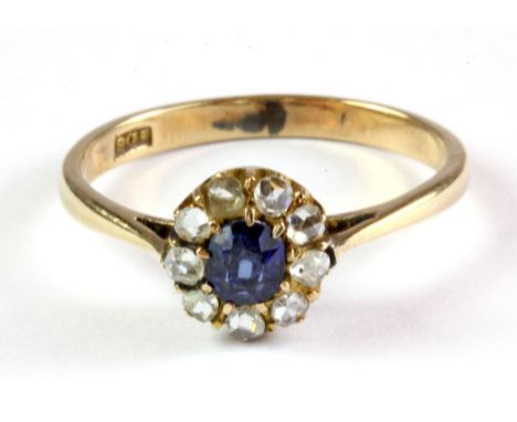 An antique 9ct yellow gold cluster ring set with an old cut sapphire and rose cut diamonds, (R.5).