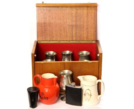 A cased set of six pewter tankards, together with two whiskey advertising jugs, spirit cups and flask.