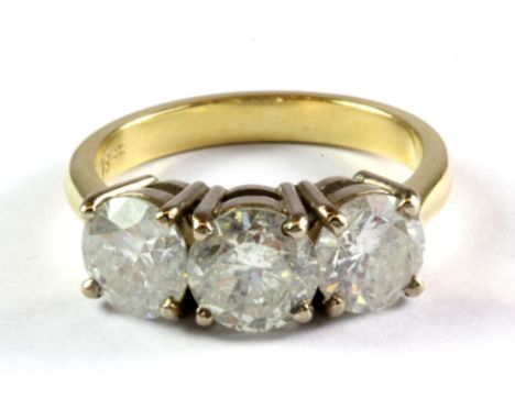 An 18ct yellow gold ring set with three brilliant cut diamonds, each approx. 1ct, overall approx. 3ct, (Q.5).