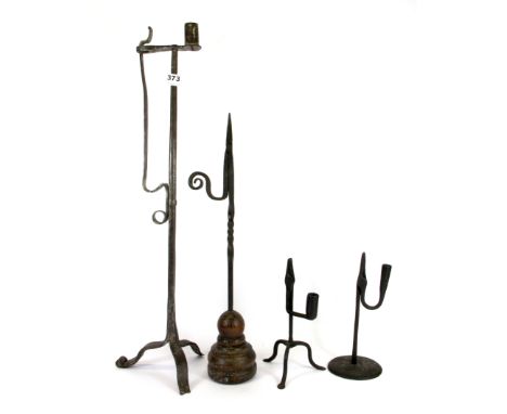 A tall iron rush light candle holder, two small rush light candle holders and a further rush light holder, tallest 67cm. Prov