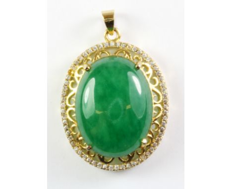 A gilt metal mounted jade set pendant, L. 3.5cm.