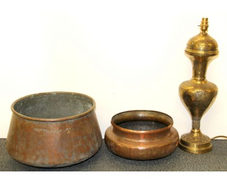 Islamic interest. A hammered and engraved Arabic copper bowl, engraved brass lamp base and a further copper bowl, largest Dia