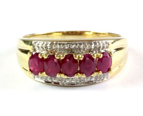 A 9ct yellow gold ruby and diamond set ring, (N.5).