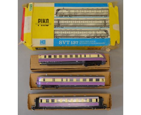 H0 Scale. Piko. 3-car articulated set. East German DR cream/purple livery. VG in P/F box.