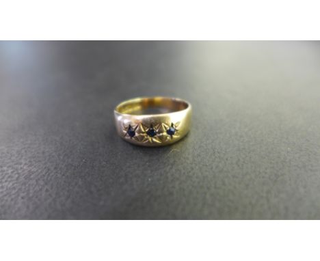 A 9ct gold sapphire three-stone band ring - Hallmarked Birmingham - Ring size K 1/2 - Weight approx 2.2gms
Condition Report: 