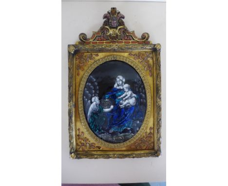 A 17th century/18th century Continental school convex enamel of Madonna and child in a gilt metal frame with decorative inset
