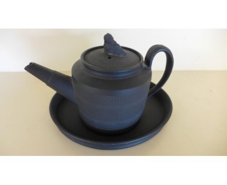 A 19th century black basalt small teapot on similar stand - Height 11cm - chips to spout and finial, repair to finial
Provena