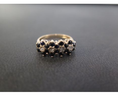 A 9ct gold sapphire and diamond quadruple cluster ring - Hallmarked London - Ring size K 1/2 - Weight approx 2.4gms
Condition