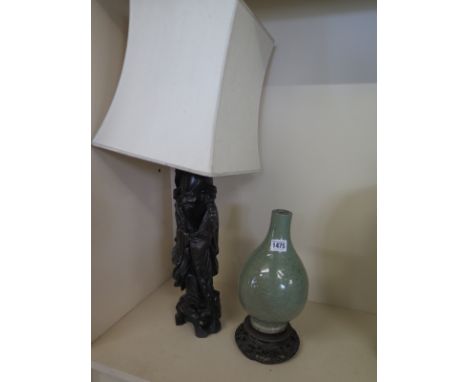 A Celadon bottle vase on a wooden stand - Height 31cm - drilled for table lamp fitting, chips to stand - and a carved wooden 