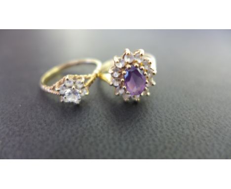 Two 9ct gold cluster rings - To include amethyst and white-gem, size K - Together with a white-gem cluster, size L 1/2 - Both