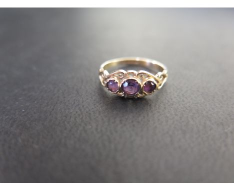 A 9ct gold amethyst three-stone ring - Hallmarked Edinburgh - Ring size J - Weight approx 1.2gms
Condition Report: Good