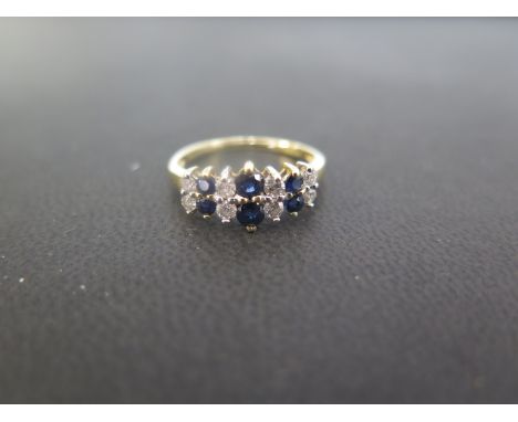 An 18ct gold sapphire and diamond two-row dress ring - Total diamond weight 0.25ct - Hallmarked London - Ring size M - Weight