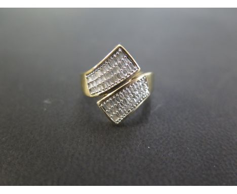 A 9ct gold baguette-cut diamond three-row crossover ring - Hallmarked Birmingham - Ring size L 1/2 - Weight approx 4.5gms
Con