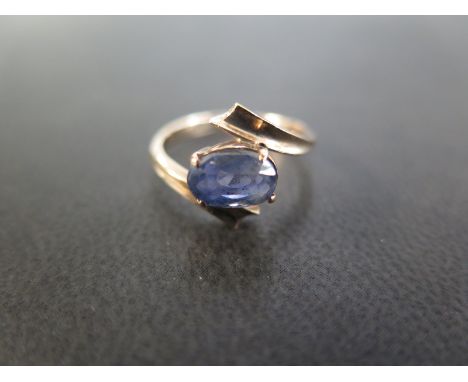 A sapphire single-stone crossover ring - Stamped 9ct - Ring size I 1/2 - Weight approx 2.9gms
Condition Report: Good 