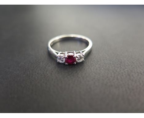 A platinum ruby and diamond three-stone ring - Estimated total diamond weight 0.25ct - Estimated G-H colour, VS clarity - Hal