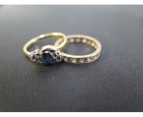 A sapphire and diamond three-stone crossover ring - Stamped 18ct and plat - Ring size M - Weight approx 3.1gms  Good to fair 