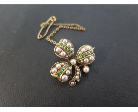 A seed pearl and peridot clover brooch - Stamped 15ct - Width 2.5cms - Weight approx 5.6gms 
Condition Report: Good to fair -