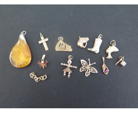 An assortment of eleven pendants and charms - All with marks indicating 9ct gold - Total weight approx 9.7gms - Together with