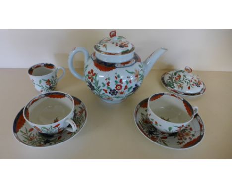 An 18th century Worcester Imari pattern teapot - Height 15cm - crack to spout, chip to finial - two cups and saucers - both c