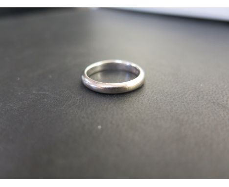A white band ring - Stamped 18ct - Ring size M - Weight approx 4.6gms
Condition Report: Good - With light surface scratches -