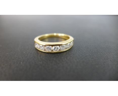 An 18ct gold diamond half-circle ring - The seven brilliant-cut diamonds within a channel setting to the plain band - Estimat
