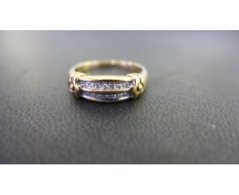 A 9ct gold diamond two-row band ring - Partial hallmark - Ring size R - Weight approx 3.2gms
Condition Report: Good - With li