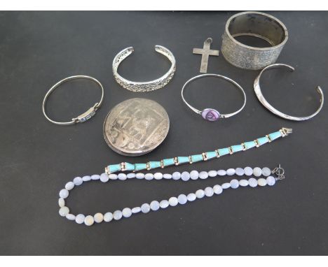 An assortment of silver and costume jewellery - To include a compact, six bangles, a cross pendant and a gem bead necklace