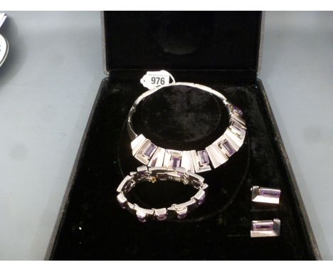 A set of amethyst jewellery - Of abstract design to include necklace 39cms, bracelet 18cms, and earrings 2.3cms - With marks 