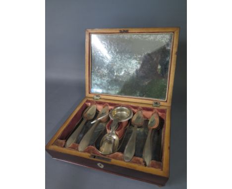 A Continental silver travelling  tea making set with twelve tea spoons, an infuser, caddy spoon and scoop and nips all housed