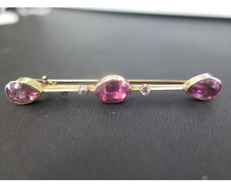 A tourmaline and diamond bar brooch - Tests as higher that 9ct gold - Length 6.5cms - Weight approx 6.6gms
Condition Report: 