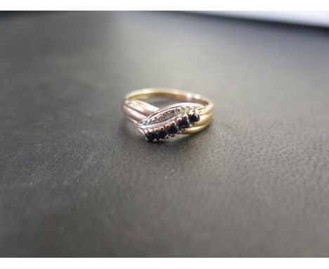 A 9ct gold sapphire and diamond crossover style ring - Hallmarked Birmingham - Ring size N - Weight approx 2.2gms
Condition R