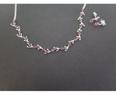 A ruby foliate necklace - To the belcher-link chain - Stamped 750 - Length 46cms - Together with a pair of matching ear penda
