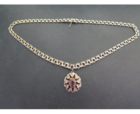 A 9ct gold fancy-link chain - Suspending an amethyst pendant - Hallmarked Sheffield - Length of pendant 3.5cms - Length of ch