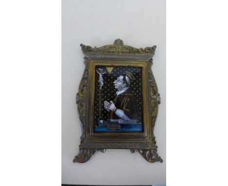 A 19th century Continental school convex enamel of a priest praying before a crucifix in a gilt metal frame S CAROLVS with in