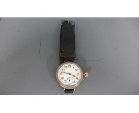 A World War One silver cased trench watch with Arabic numerals to white enamel circular dial, subsidiary second hand at 6 o'c