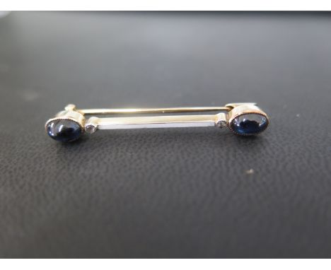 An early 20th centurygold sapphire cabochon, diamond and enamel bar brooch  - Length 4cms - Weight approx 3.3gms
Condition Re