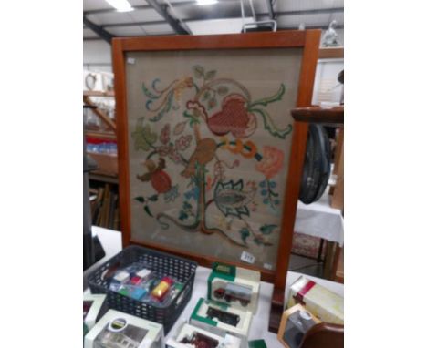 An oak fire screen with embroidered panel.