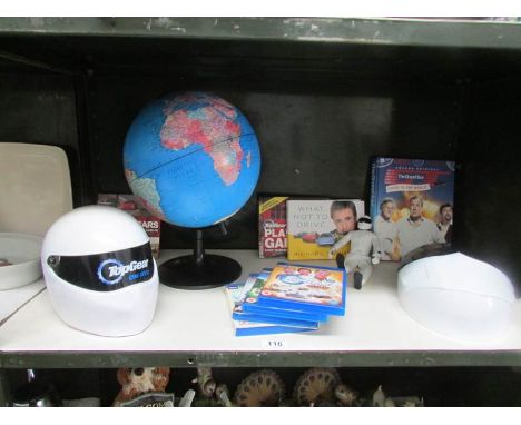 A shelf of Top Gear collectables and a table globe.