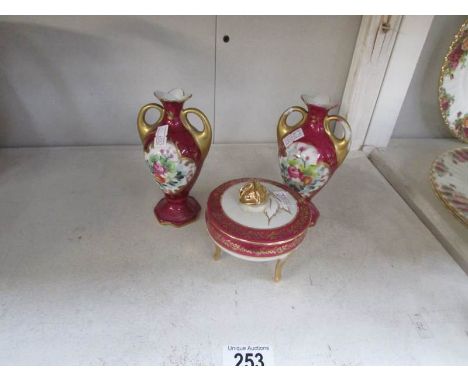 A Limoges trinket pot and a pair of vases.