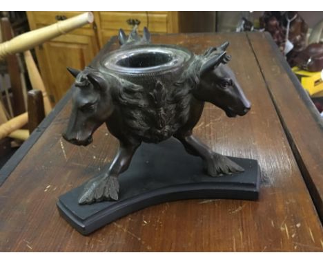 A 19th century Italian Grand Tour bronze inkwell, modelled as three horses heads supported by stylised feet, on a black slate