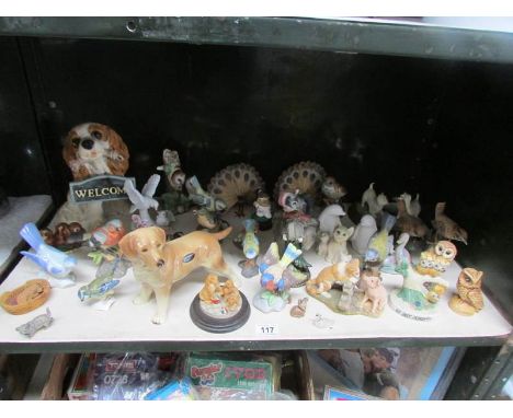 A shelf of animal figures including Cooper craft dog,. Goebel etc.,