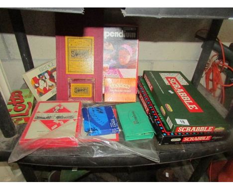 A shelf of games including scrabble.