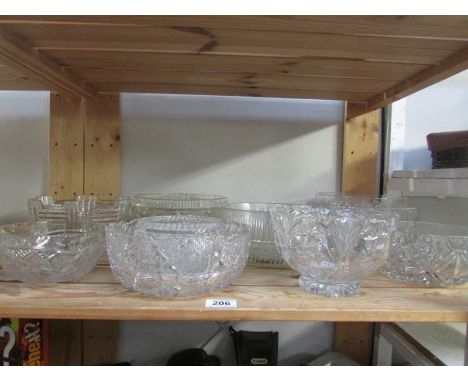 A shelf of assorted glass bowls,