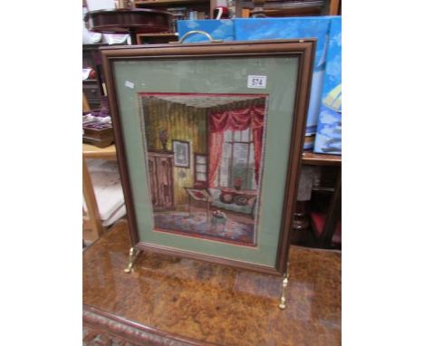 A fire screen with tapestry inset.