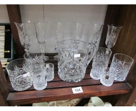 A shelf of assorted glass ware.