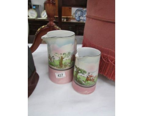 2 graduated jugs with hunting scenes.