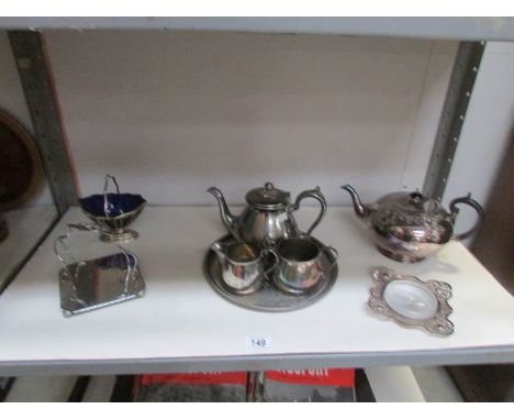 A 3 piece silver plate tea set and other silver plate items (1 shelf).