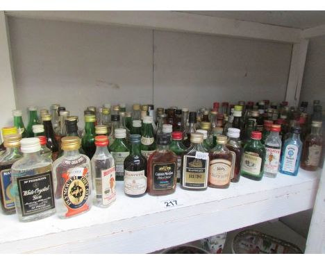 A shelf of alcohol miniatures.