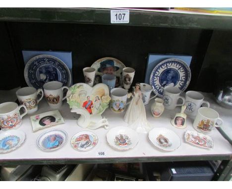 A shelf of commemorative china.