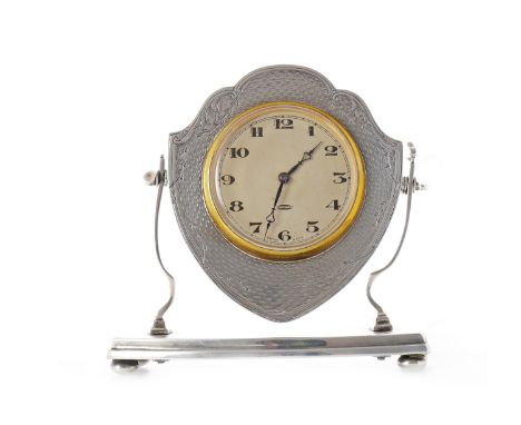 GEORGE V SILVER MOUNTED DESK CLOCK maker Henry Matthews, Birmingham 1929, the clock set in swivel mounted shield-shaped silve